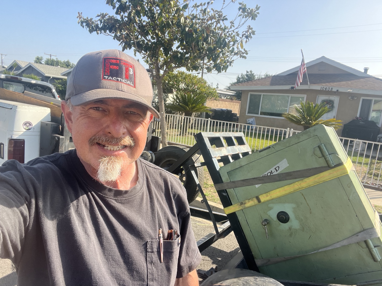 Jose Velasco with a large safe strapped to the moving trailer